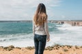 The girl in solitude admires a beautiful view of the Atlantic Ocean.