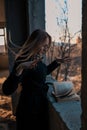 Girl sorceress leafing through a book of spells Royalty Free Stock Photo