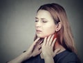 Girl with sore throat neck colored in red. Sick woman having pain in throat Royalty Free Stock Photo