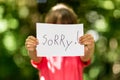 Girl with Sorry sign Royalty Free Stock Photo