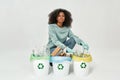 Girl sort garbage in glass, plastic or paper bins