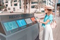 Girl sorts and throws garbage in a street station for recycling plastic waste. Environment conservation concept Royalty Free Stock Photo