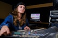 Girl sound engineer controls the mixing console. Professional recording of singers in the Studio. Young woman at the controls in Royalty Free Stock Photo