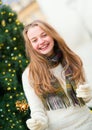 Girl with a sparkler near brightly Christmas tree