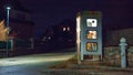 girl speaks in the night telephone booth. mystical and mysterious street phone