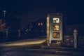 girl speaks in the night telephone booth. mystical and mysterious street phone