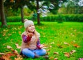 Girl spending time in the autumn park Royalty Free Stock Photo