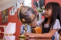 Girl spinning a mock globe for fun