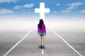 Girl in a spiritual journey with a cross Royalty Free Stock Photo