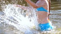 Girl splashes with water.