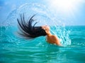 Girl Splashing Water with her Hair Royalty Free Stock Photo