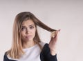 Girl with split hair problem perplexity Royalty Free Stock Photo