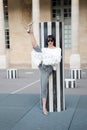 Girl split leg at striped column in paris, france Royalty Free Stock Photo