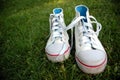 Girl sport shoes in the grass