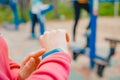 Girl sport uses finger touches fitness bracelet to measure heart rate and number steps, useful technology Royalty Free Stock Photo