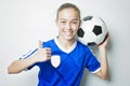 Girl in sport wear with football on white background