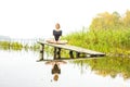 Girl with sports figure on background of calm autumn river. Yoga, Meditation, Relax Royalty Free Stock Photo
