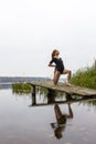 Girl with sports figure on background of calm autumn river. Yoga, Meditation, Relax Royalty Free Stock Photo