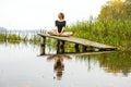 Girl with sports figure on background of calm autumn river. Yoga, Meditation, Relax Royalty Free Stock Photo