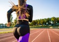 Girl sportsman crossfit and squats agains at sunset in the stadium Royalty Free Stock Photo