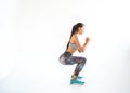 Girl sportsman crossfit and squats against white background