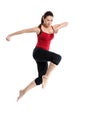 Girl in sportswear jumping over white