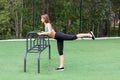 Girl in sportswear on the playground doing fitness.