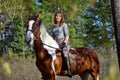 Girl sportswoman and her horse in the spring