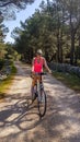 Punat - A girl riding a bike through the forest Royalty Free Stock Photo