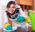 Girl with spray and rag cleaning shelves Royalty Free Stock Photo