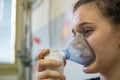 The girl is spraying bronchodilators to treat respiratory symptoms racers at the emergency room of the hospital