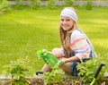 Girl sprays plants in the garden