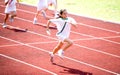Girl sprints towards the finishing line.