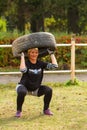 Girl squat with the tire.