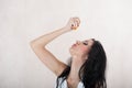 Girl squeezes an orange. portrait of a girl with an orange. Orange pleasure. woman squeezing juice from fresh orange with hands Royalty Free Stock Photo