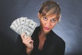 Girl with stack of dollar bills Royalty Free Stock Photo