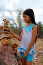 Girl stacking rocks Royalty Free Stock Photo