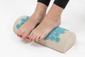 girl standing on applicators doing foot massage on a massage Mat