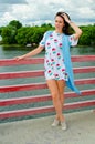 A girl standing on a balcony above the river Royalty Free Stock Photo