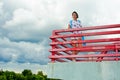 A girl standing on a balcony above the river Royalty Free Stock Photo