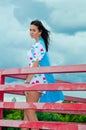 A girl standing on a balcony above the river Royalty Free Stock Photo