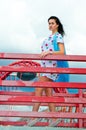 A girl standing on a balcony above the river Royalty Free Stock Photo