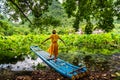 Girl on bamboo raft in lotus flower lake Royalty Free Stock Photo