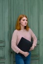 Girl standing with a black folder in hands Royalty Free Stock Photo