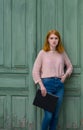 Girl standing with a black folder in hands Royalty Free Stock Photo