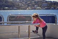 Girl standing on board of the yacht. Vacation on a yacht. Cruise on the ship. Journey across the ocean. Royalty Free Stock Photo