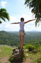 Girl is standing on the chopped tree