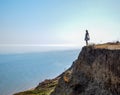 The girl is standing on a cliff near the sea Royalty Free Stock Photo