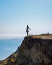 The girl is standing on a cliff near the sea Royalty Free Stock Photo