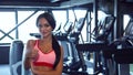 Beautiful girl stands in the gym and shows thumbs up